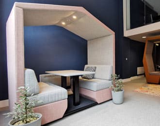 Upholstered office den with seating and table