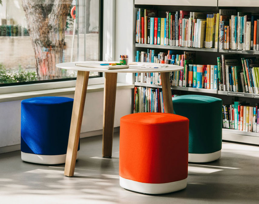 Puck stools at table in library